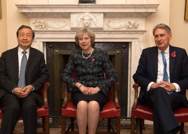 Prime Minister Theresa May and Chancellor Philip Hammond greet China's Vice Premier Ma Kai  Carl Court/PA Wire