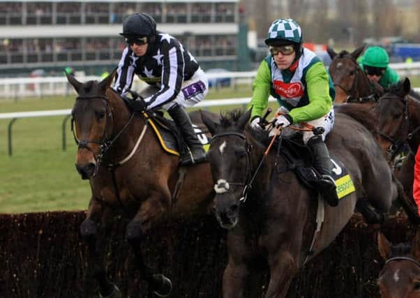 Gold Cup winner Imperial Commander ridden by Paddy Brennan (left) winner and second placed Denman ridden by Tony McCoy during the early stages of the Totesport Cheltenham Gold Cup Steeple Chase.