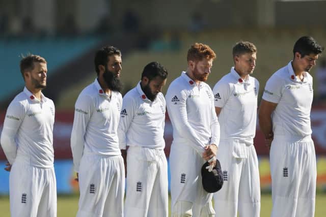 England's cricketers pay their respects on Armistice Day before the start of the third day (AP Photo/Rafiq Maqbool)