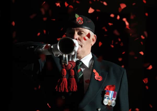 Bugler Stan Wilkinson plays the Last Post during a remembrance service on Armistice Day at the Royal Armouries, Leeds. Picture Tony Johnson