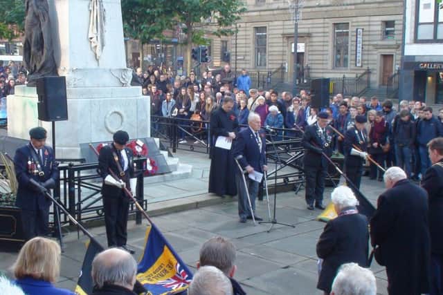 Members of the British Legion and the  public observe a two minute silence in Leeds on  Armistice Day.