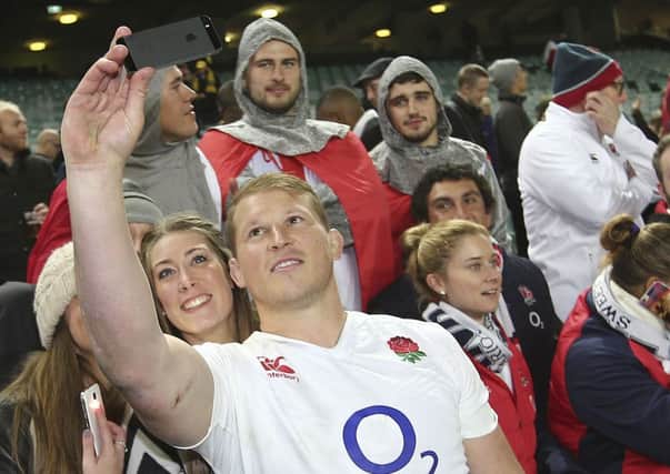 England's Dylan Hartley takes a selfie with fans after their rugby test match against Australia in Sydney. England made a clean sweep 3-0.