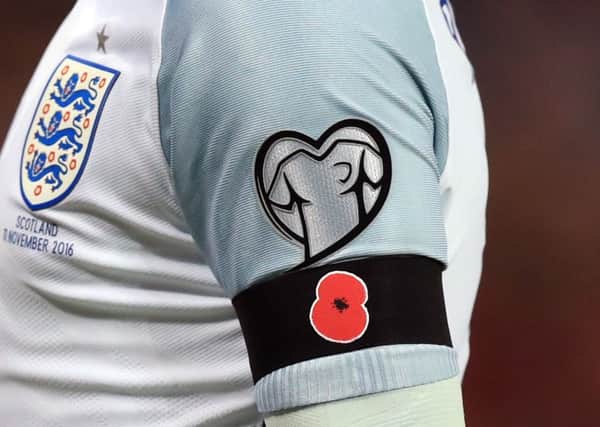 England captain Wayne Rooney sporting the poppy on his armband against Scotland last night (Picture: Mike Egerton/PA).
