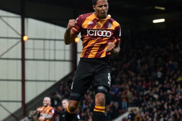Timothee Dieng leaps into the air after scoring Bradford's second