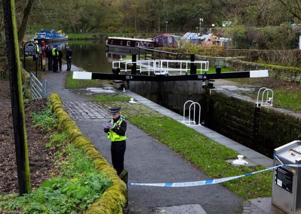 Police at the canal towpath close to where the body was found.