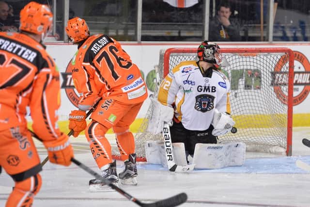 THUNDERBOLT: Colton Fretter, far left, fires past Jindrich Pacl to give Sheffield Steelers a 4-0 lead against Nottingham Panthers. Picture: Dean Woolley.