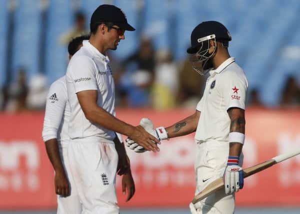 Indian cricket captain Virat Kohl, right, shakes hand with England's cricket captain Alastair Cook at the end of the first Test match in Rajkot. Picture: AP Photo/Rafiq Maqbool