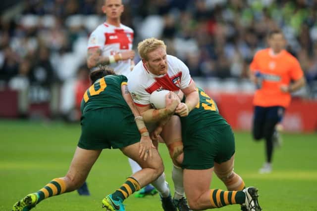 England's James Graham is tackled by Australia's Aaron Woods (left) and Trent Merrin Picture: Nigel French/PA