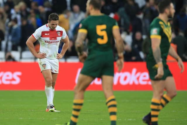 England captain Sam Burgess, left, shows his dejection after the final whistle against Australia with his side beaten 36-18 by their opponents at London Stadium (Picture: Nigel French/PA).