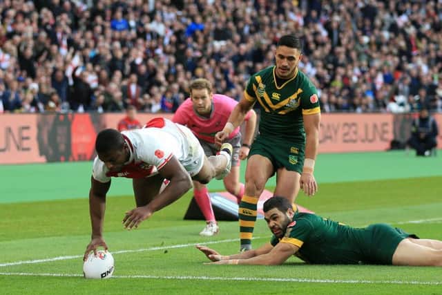 England's Jermaine McGillvary (left) scores the opening try of the game against Australia at London Stadium. Picture: Nigel French/PA