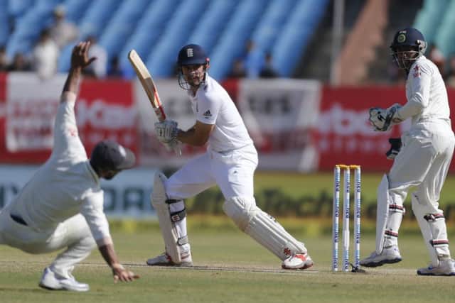 GENTLY DOES IT: England captain Alastair Cook squeezes the ball through India's slip cordon in Rajkot yesterday. Picture: AP/Rafiq Maqbool