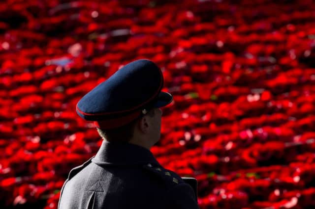 A soldier looks out over poppy wreaths laid at the Cenotaph memorial during the annual Remembrance Sunday Service in Whitehall, central London, held in tribute for members of the armed forces who have died in major conflicts. PRESS ASSOCIATION Photo. Picture date: Sunday November 13, 2016. See PA story MEMORIAL Remembrance. Photo credit should read: Dominic Lipinski/PA Wire