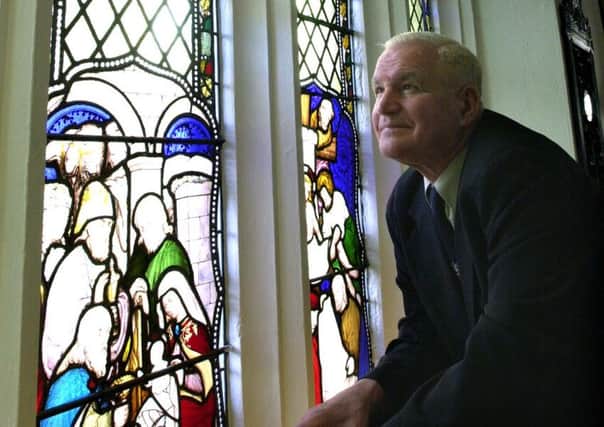 Peter Gibson with one of the stained glass windows at the Spurriergate Centre, York