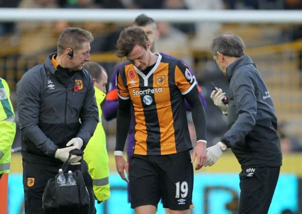 Hull City's Will Keane (centre) leaves the pitch an injury during the Premier League match at the KCOM Stadium, Hull.