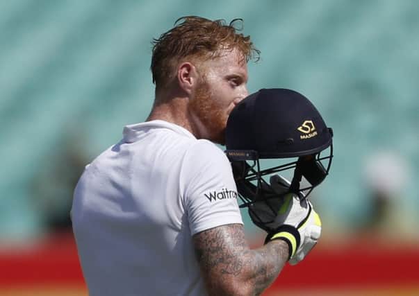 England's batsman Ben Stokes kisses his helmet after scoring a hundred against India in Rajkot. (AP Photo/Rafiq Maqbool)