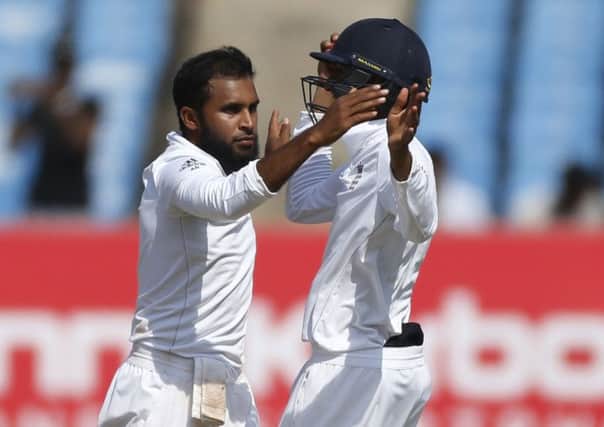 England's bowler Adil Rashid, left, celebrates the wicket of Indian batsman Ravindra Jadeja. (AP Photo/Rafiq Maqbool)