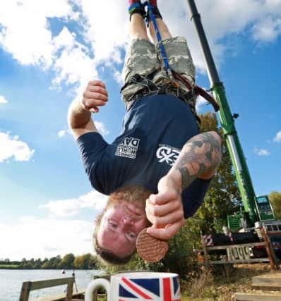 Craig Glenday and Sofia Greenacre of Guinness World Records confirm the record  for the highest dunk of a biscuit by a bungee jumper, which is 73.41 m (240 ft 10 in)