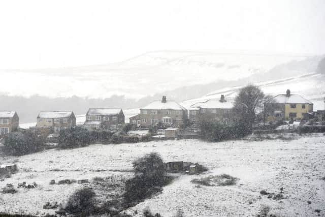 Covered houses in the Peak District after winter weather brought snow to high ground