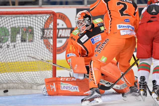 IN FRONT: Patrick Asselin, far right, pokes the puck home past Ervins Musukovs to put Cardiff 3-2 up against Sheffield Steelers on Friday night. Picture: Dean Wooley.