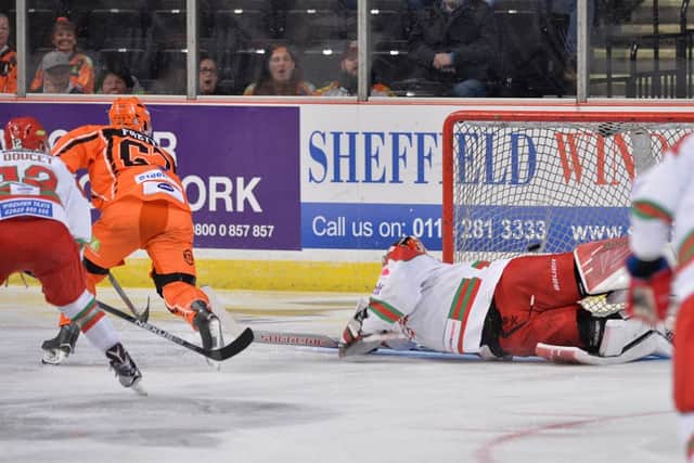 DOUBLE  ME UP: Colton Fretter backhands the puck past Ben Bowns to put Sheffield 2-0 up against Cardiff. Picture: Dean Wooley.