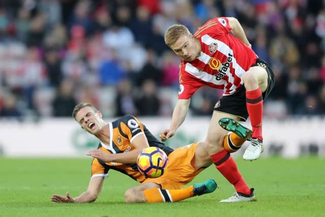 Sunderland's Duncan Watmore (right) and Hull City's Michael Dawson battle for the ball (PA)