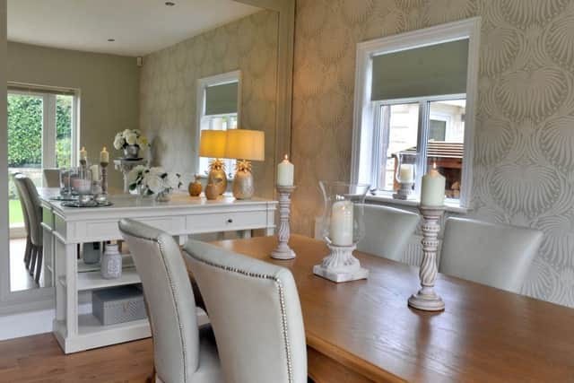 The dining area in the kitchen where a large mirror adds interest and reflects light..