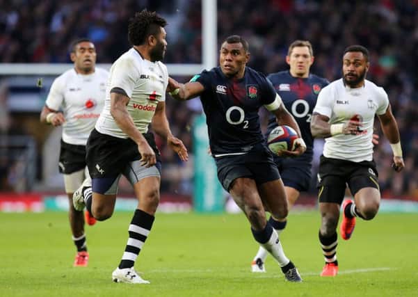 Out of my way: Englands Semesa Rokoduguni, centre, brushes off a Fijiian opponent en route to a two-try performance from the Bath flier in only his second cap. (Picture: Gareth Fuller/PA)