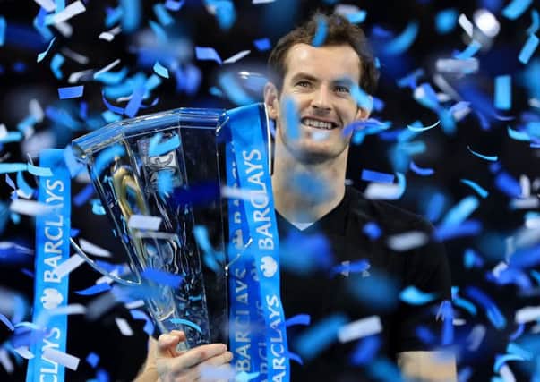 World No 1 Andy Murray poses with the trophy after winning the Barclays ATP World Tour Finals at The O2, London (Picture: Adam Davy/PA).