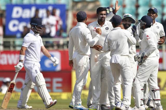 ON THE WAY OUT? Englands Ben Duckett, left, leaves the field after another failure, falling for a duck to Indias Ravichandran Ashwin in the second innings on the last day of the second Test in Visakhapatnam. Picture: AP/Aijaz Rahi