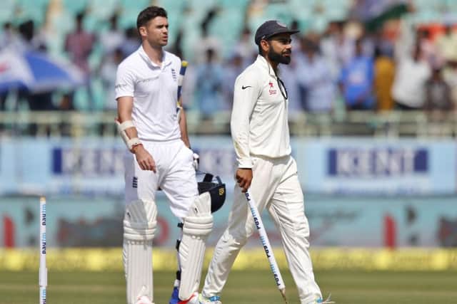 STUMPED: India captain Virat Kohli, right, carries a wicket as a souvenir with Englands James Anderson following after the hosts won by 246 runs . Picture: AP/Aijaz Rahi