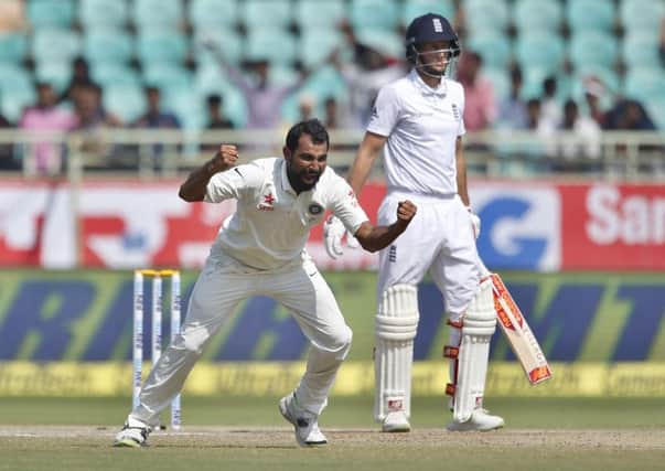 India's Mohammed Shami, left, celebrates the dismissal of England's Joe Root, right, on the last day in Visakhapatnam. Picture: AP /Aijaz Rahi.