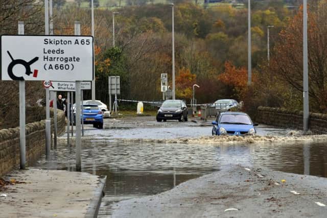 Abandoned cars are left on the A65 near Ilkley, after overnight flooding
