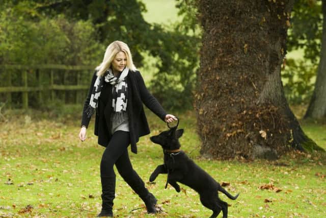Kelly Holder with her three-month-old German Shepherd 

JENNY WOOLGAR PHOTOGRAPHY
