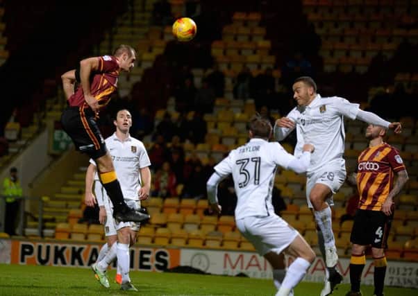 James Hanson heads in Bradford's goal against Northampton Town. (Picture: Bruce Rollinson)