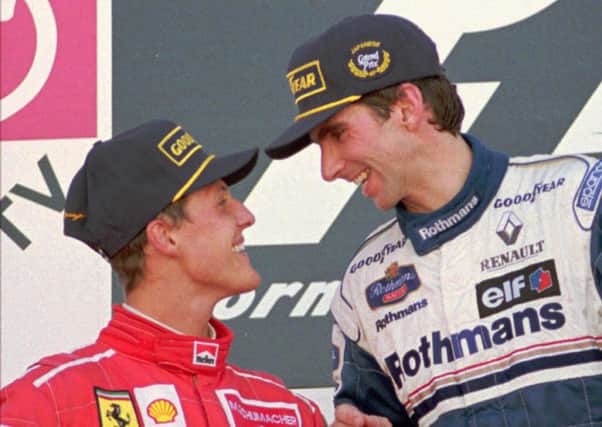 Formula One Japanese Grand Prix winner Damon Hill  and runner-up Michael Schumacher exchange some words on the podium.