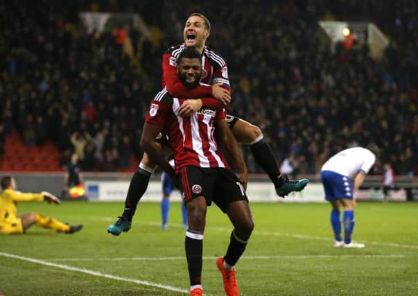 IMPACT PLAYER: Sheffield United's Ethan Ebanks-Landell celebrates his late winning goal against Bury with Billy Sharp. Picture: Simon Bellis/Sportimage