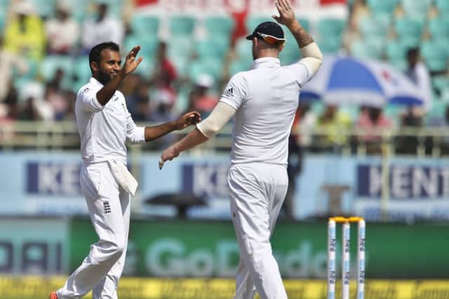 LEADING THE WAY: England's Adil Rashid, left, celebrates the wicket of India's Umesh Yadav with team-mate Ben Stokes in the second Test in Visakhapatnam. Picture: AP/Aijaz Rahi.