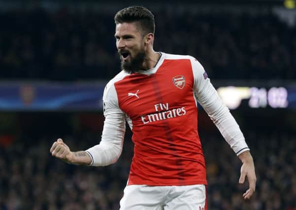 Arsenal's Olivier Giroud celebrates ahis side's second goal during the Champions League Group A soccer match against Paris Saint Germain. It ended 2-2. Picture: AP/Alastair Grant
