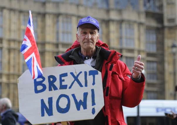 A pro-Brexit demonstrator outside the Houses of Parliament on the day of the Autumn Statement.