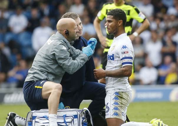 Leeds United's Liam Bridcutt (right) is given treatment during the Championship match at Elland Road against Huddersfield in September. Picture: Danny Lawson/PA.