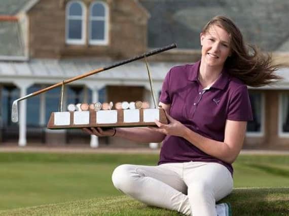 Rotherham's Olivia Winning with the Helen Holm Scottish stroke play trophy.