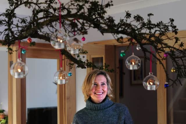 Jo with the branch pruned from a California Lilac and  decorated with tealight holders and baubles.
