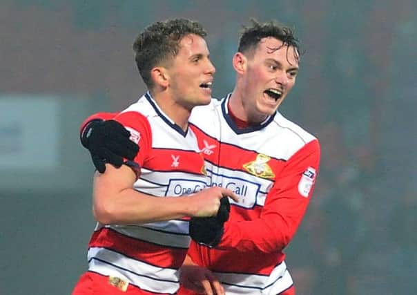Doncaster Rovers' Jordan Houghton, left, is congratulated after his first goal for the club by striker Liam Mandeville, who slotted home two second-half penalties against Leyton Orient (Pictures: James Hardisty).