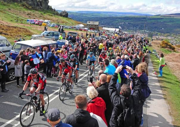 The peloton of the Tour de Yorkshire make their way through the crowds near the Cow and Calf in Ilkley. (YPN).