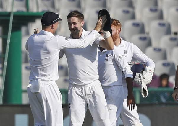 England's cricketers celebrate the dismissal of India's Cheteshwar Pujara.