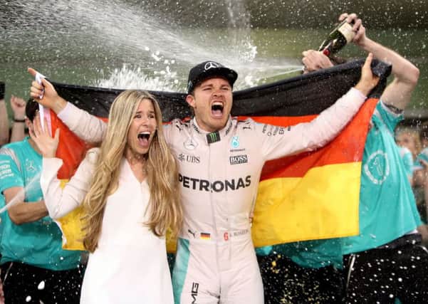 Mercedes' Nico Rosberg celebrates winning the Formula One world championship with wife Vivian and the Mercedes team.