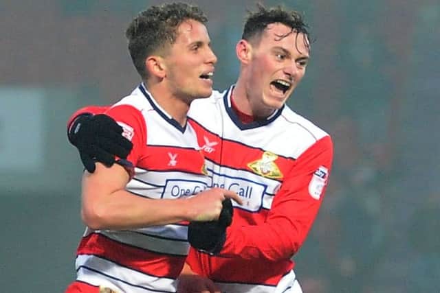 Doncaster Rovers' Jordan Houghton celebrating his goal with Liam Mandeville, right, who notched two penalties