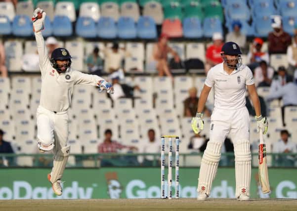 India wicketkeeper Parthiv Patel celebrates after taking a catch off Jonny Bairstow