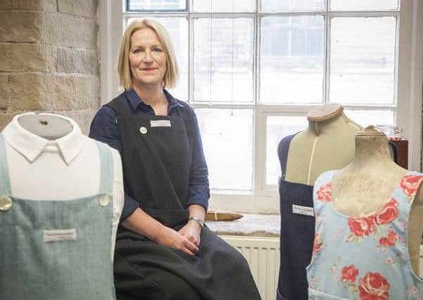 Charlotte Meek surrounded by some of her designs  in her studio at Salts Mill, Saltaire