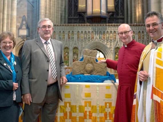 Enid and Peter Nutland (l) from the Blackpool Church return the ancient cross to Canon Barry Pyke, Canon for Rural Engagement and Education and Ripon Cathedral Dean, The Very Rev. John Dobson (s).